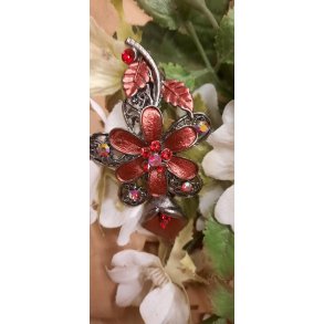 Hrspnde metal som rd blomst med stor krystal i midten af blomsten 